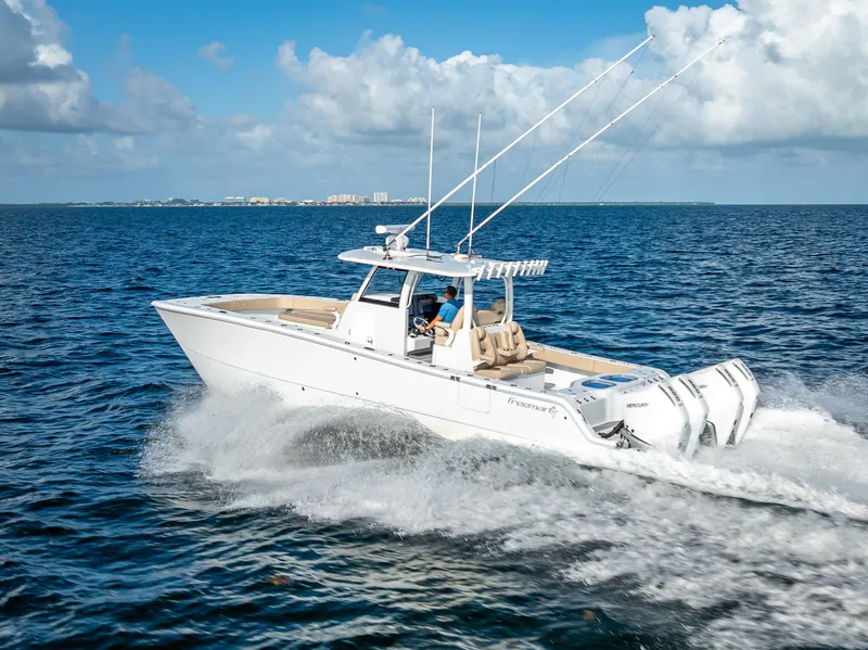 Slide: The Image of 2025 Freeman 35 boat cruising on open water under a clear blue sky. - 7