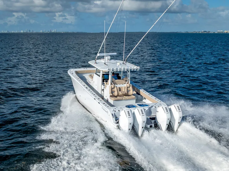 Slide: The Image of 2025 Freeman 35 boat cruising on open water with four powerful engines. - 8