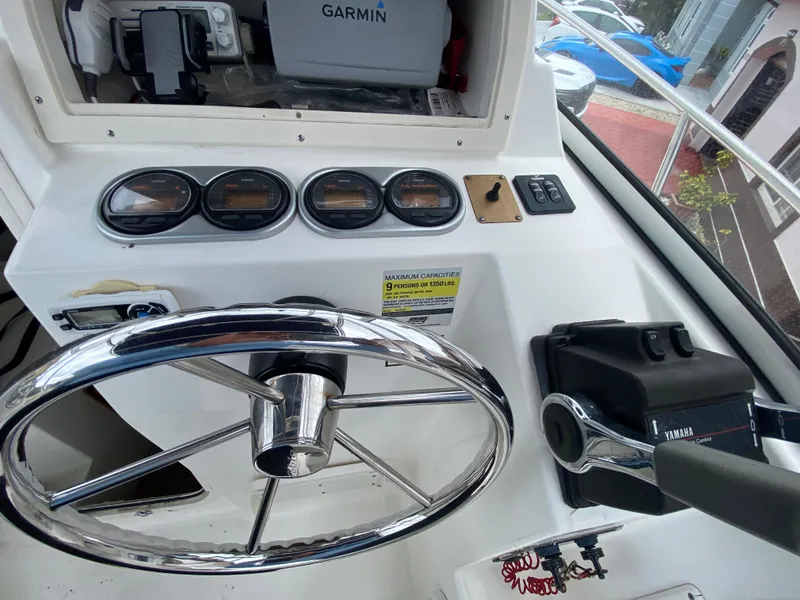 Slide: The Image of 2004 Cobia 250 Walk-Around boat dashboard with Garmin GPS and Yamaha controls. - 26