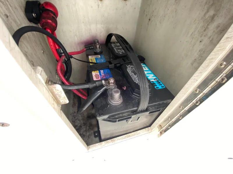 Slide: The Image of Battery compartment of a 2004 Cobia 250 Walk-Around boat with visible wiring. - 30