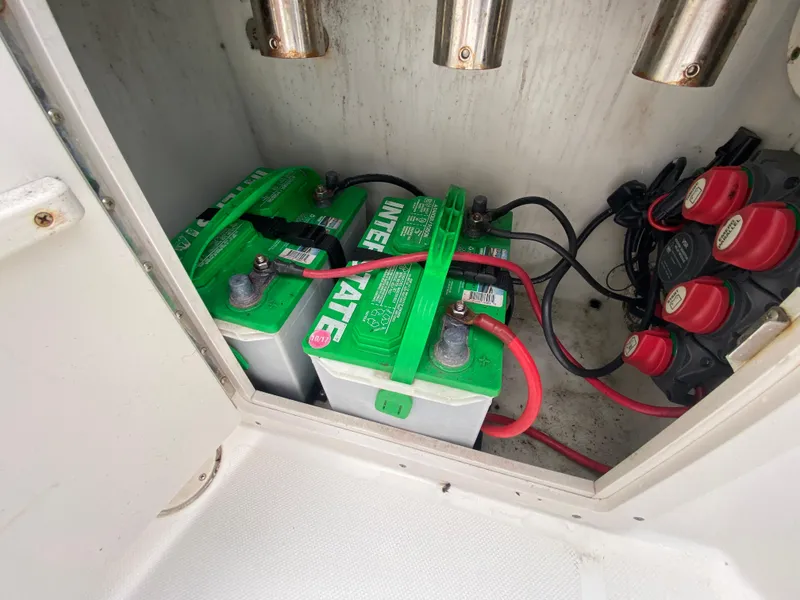 Slide: The Image of 2004 Cobia 250 Walk-Around boat battery compartment with Interstate batteries and wiring. - 31