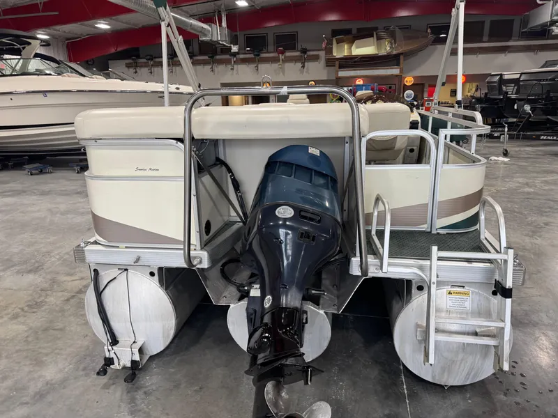 Slide: The Image of 2004 Bennington 2575 pontoon boat with outboard motor in a showroom. - 6