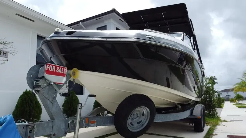 Slide: The Image of 2013 Yamaha SX240 HO boat on trailer, black hull, "For Sale" sign displayed. - 10