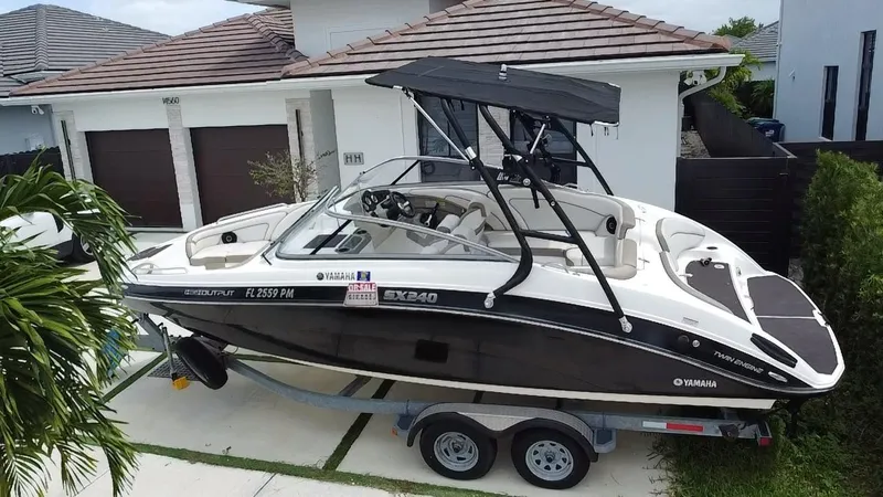 Slide: The Image of 2013 Yamaha SX240 HO boat on trailer in residential driveway. - 11