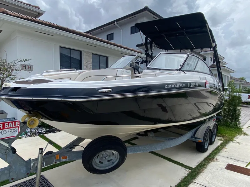 Slide: The Image of 2013 Yamaha Boats SX240 HO on trailer, parked in residential driveway, for sale sign visible. - 12