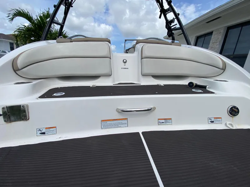 Slide: The Image of 2013 Yamaha Boats SX240 HO rear deck with cushioned seating and sleek design. - 15