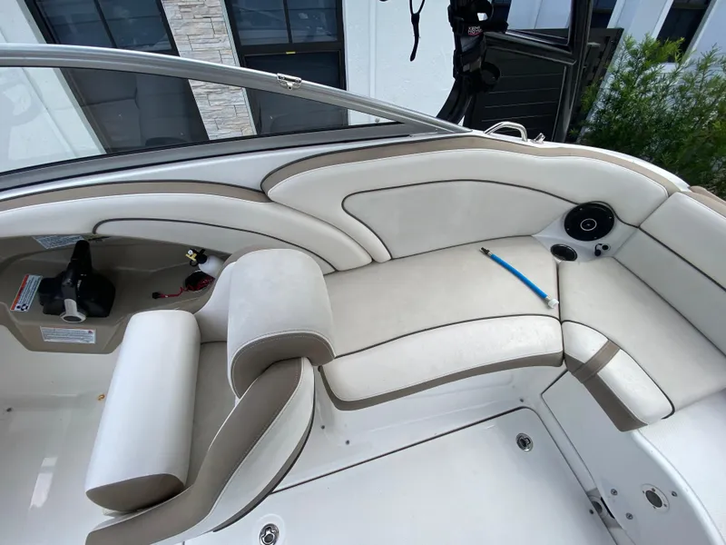 Slide: The Image of 2013 Yamaha Boats SX240 HO interior with white cushioned seating and speaker. - 17