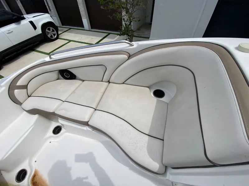 Slide: The Image of 2013 Yamaha Boats SX240 HO interior seating with white and beige upholstery. - 19