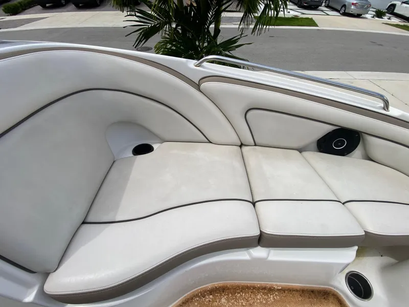 Slide: The Image of 2013 Yamaha Boats SX240 HO interior seating with white upholstery and speaker. - 20