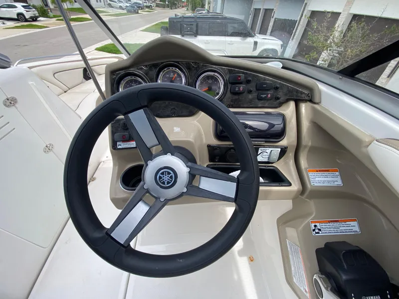 Slide: The Image of 2013 Yamaha Boats SX240 HO dashboard with steering wheel and control panel. - 21