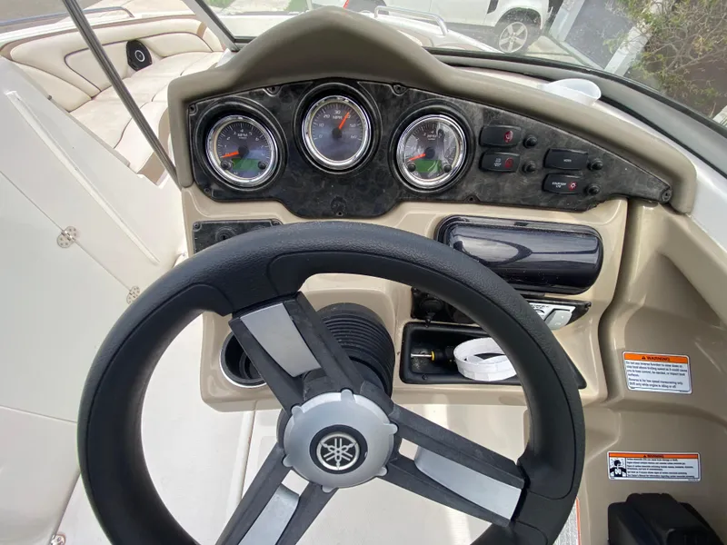 Slide: The Image of 2013 Yamaha Boats SX240 HO dashboard with steering wheel and gauges. - 22