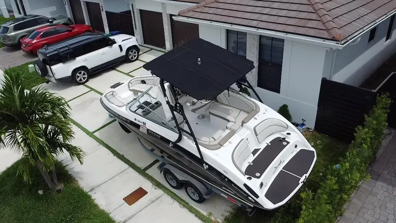 Slide: The Image of 2013 Yamaha Boats SX240 HO on trailer, parked in residential driveway. - 23