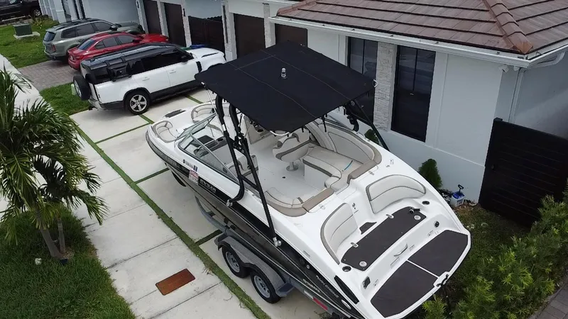 Slide: The Image of 2013 Yamaha Boats SX240 HO parked on trailer in residential driveway. - 26