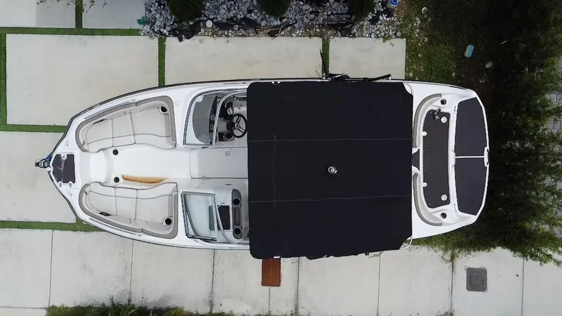 Slide: The Image of Overhead view of a 2013 Yamaha Boats SX240 HO, docked on a concrete surface. - 28