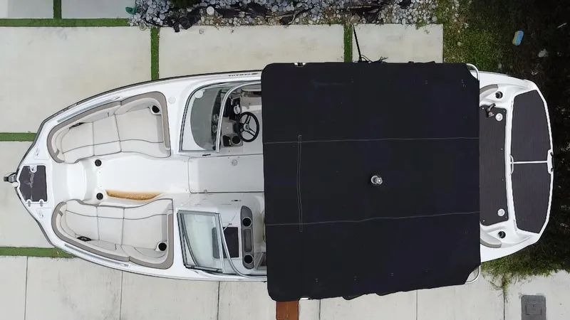 Slide: The Image of Overhead view of a 2013 Yamaha Boats SX240 HO with a black cover. - 29
