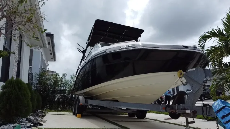 Slide: The Image of 2013 Yamaha Boats SX240 HO on trailer, parked in residential driveway. - 3