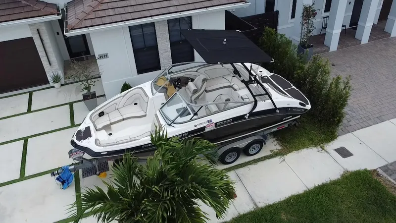 Slide: The Image of 2013 Yamaha Boats SX240 HO on trailer, parked in residential driveway. - 5