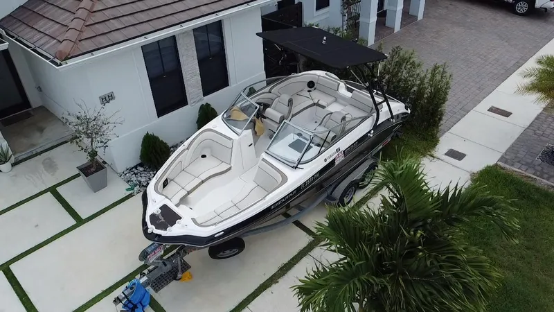 Slide: The Image of 2013 Yamaha Boats SX240 HO parked in a driveway, aerial view. - 9