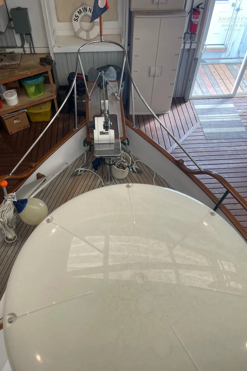 Slide: The Image of Grand Banks 36 Classic 1969 boat interior with wooden deck and nautical equipment. - 16