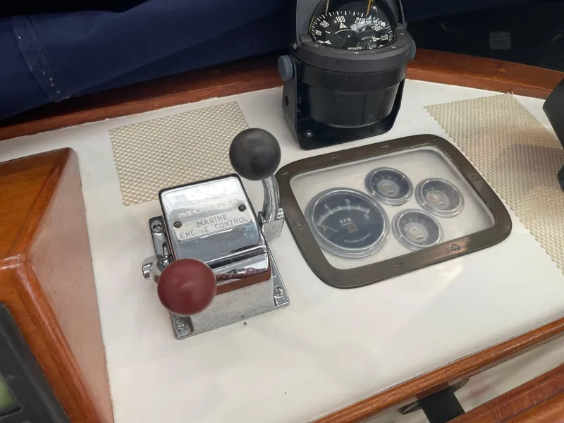 Slide: The Image of 1969 Grand Banks 36 Classic marine engine controls and compass on the dashboard. - 18