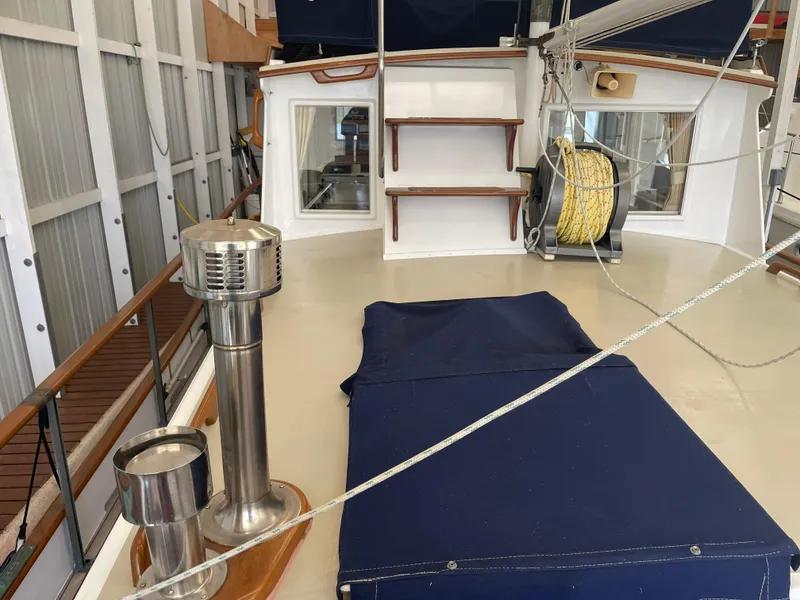 Slide: The Image of 1969 Grand Banks 36 Classic yacht deck with blue cover and stainless steel fittings. - 22