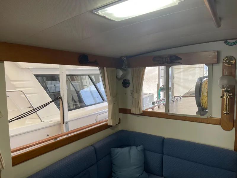 Slide: The Image of Interior of 1969 Grand Banks 36 Classic yacht with blue seating and wooden accents. - 25