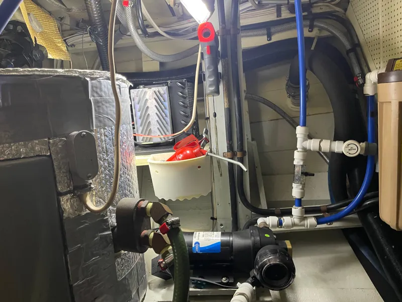 Slide: The Image of Engine room of a 1969 Grand Banks 36 Classic boat with plumbing and equipment. - 27