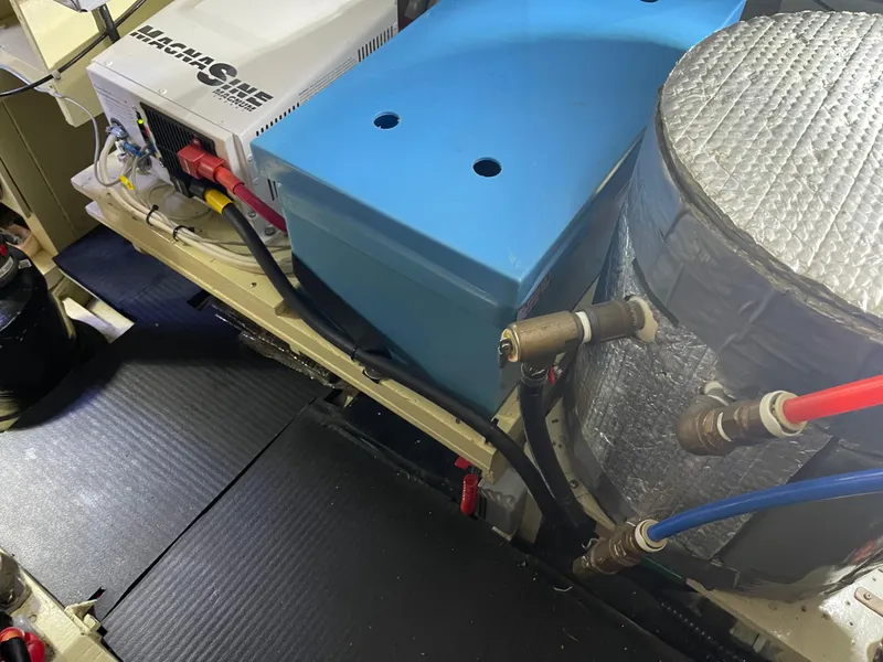 Slide: The Image of Engine room of 1969 Grand Banks 36 Classic with electrical components and insulated pipes. - 28