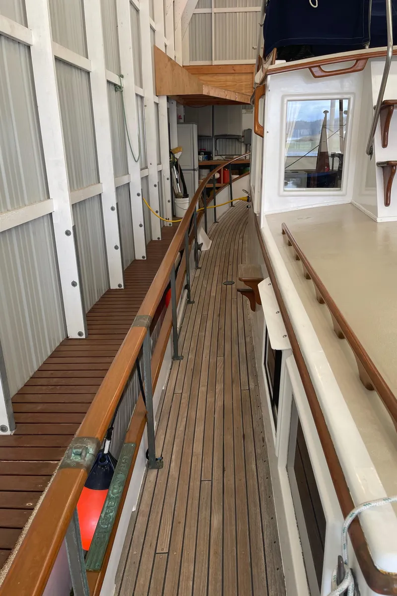 Slide: The Image of Side deck of 1969 Grand Banks 36 Classic yacht in a marina setting. - 30
