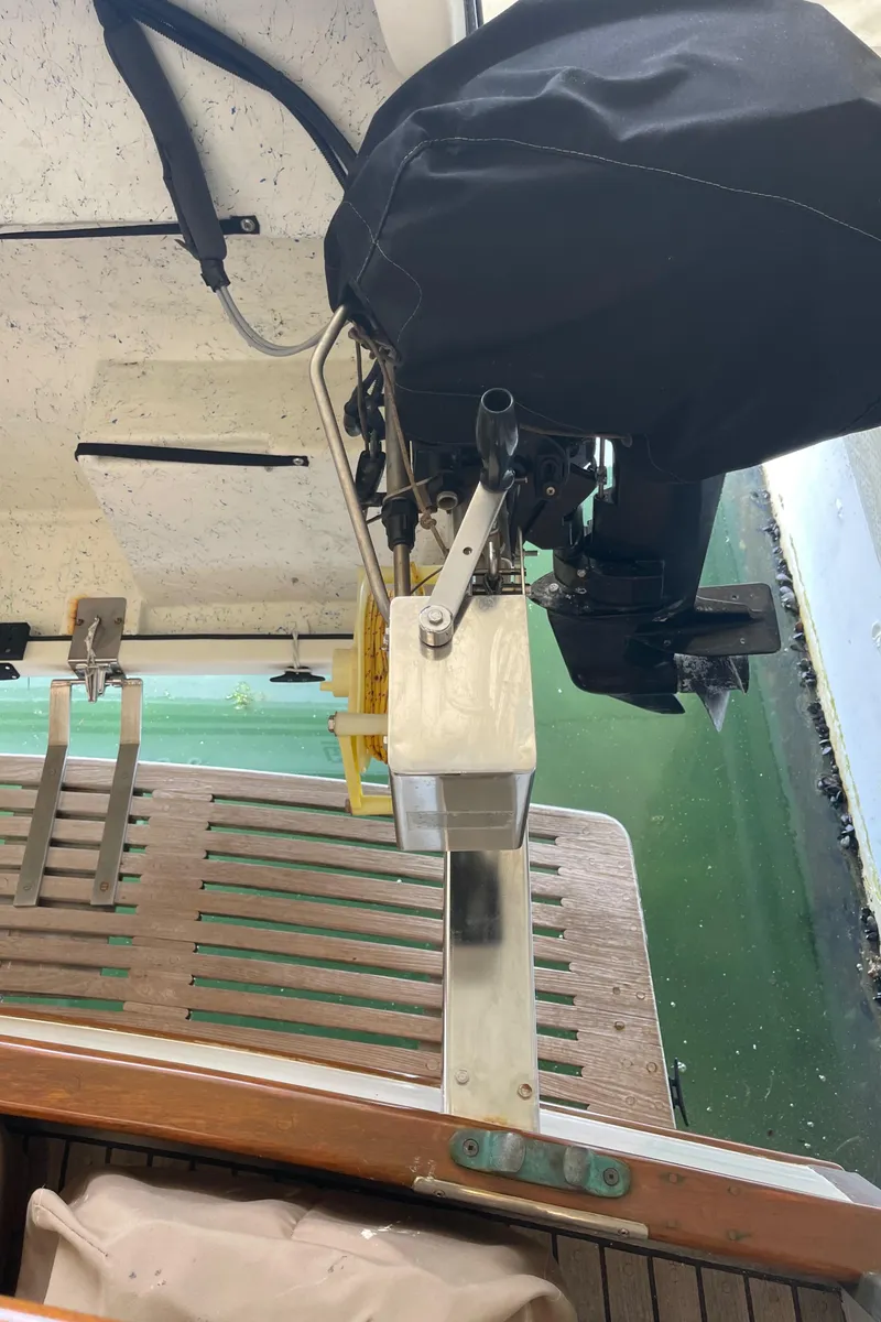 Slide: The Image of 1969 Grand Banks 36 Classic boat with covered outboard motor and wooden deck. - 32