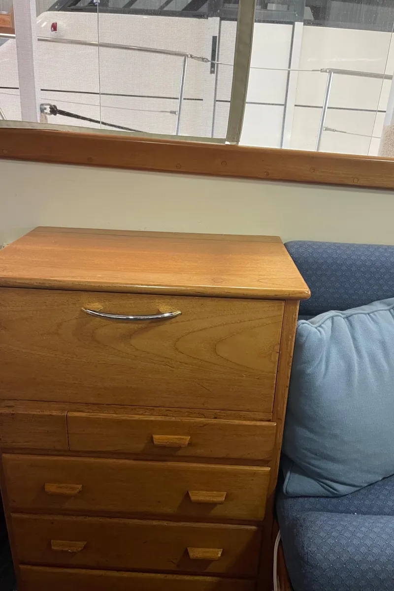 Slide: The Image of Wooden cabinet and blue sofa inside a 1969 Grand Banks 36 Classic boat. - 33