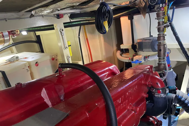Slide: The Image of Engine room of a 1969 Grand Banks 36 Classic with red engine components. - 35