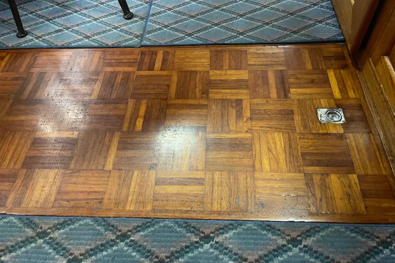 Slide: The Image of Wooden parquet flooring on a 1969 Grand Banks 36 Classic boat interior. - 37