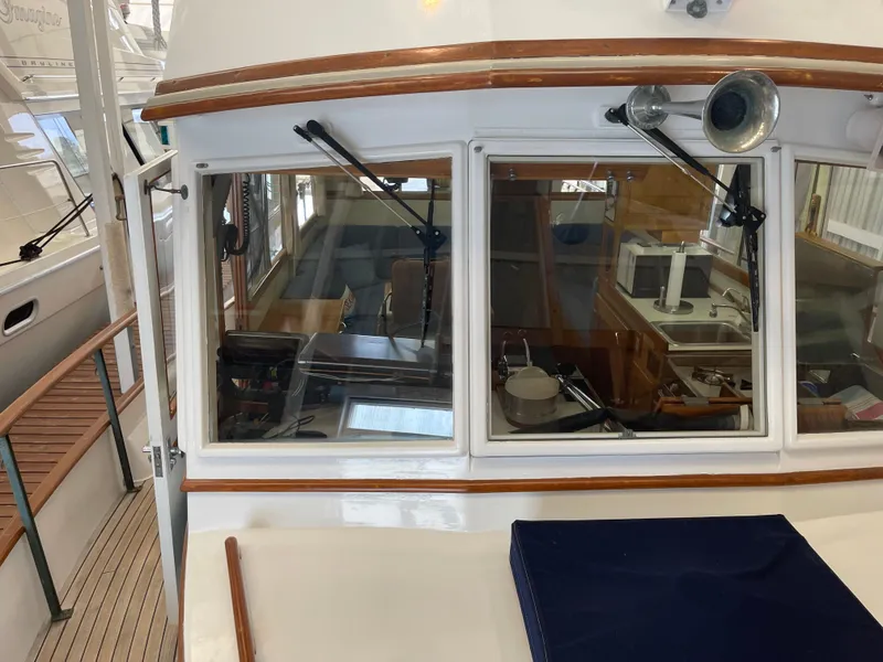 Slide: The Image of 1969 Grand Banks 36 Classic yacht interior with kitchen and seating area visible through windows. - 4