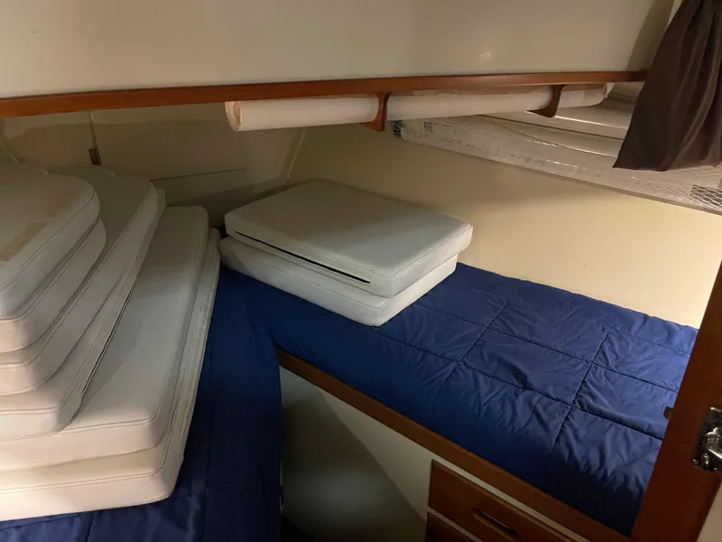 Slide: The Image of Cabin interior of 1969 Grand Banks 36 Classic with blue bedding and stacked cushions. - 40