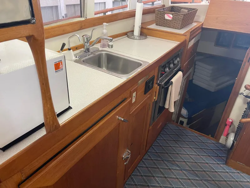 Slide: The Image of Interior of 1969 Grand Banks 36 Classic boat featuring a compact kitchen area. - 47