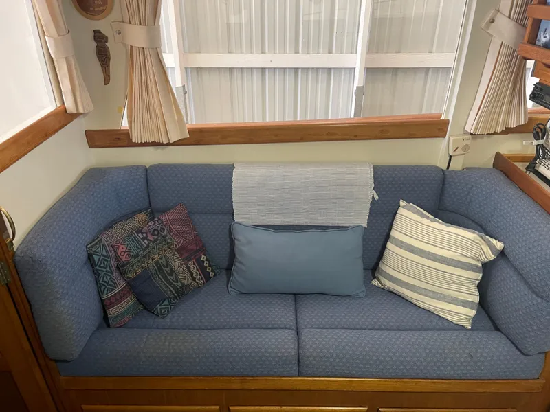 Slide: The Image of Interior of 1969 Grand Banks 36 Classic with blue sofa and decorative pillows. - 48