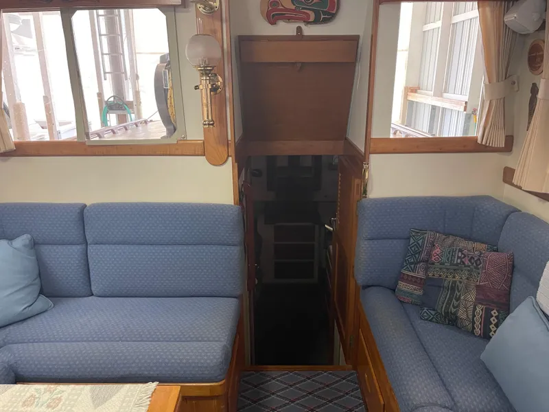 Slide: The Image of Interior of 1969 Grand Banks 36 Classic with blue seating and wooden accents. - 49