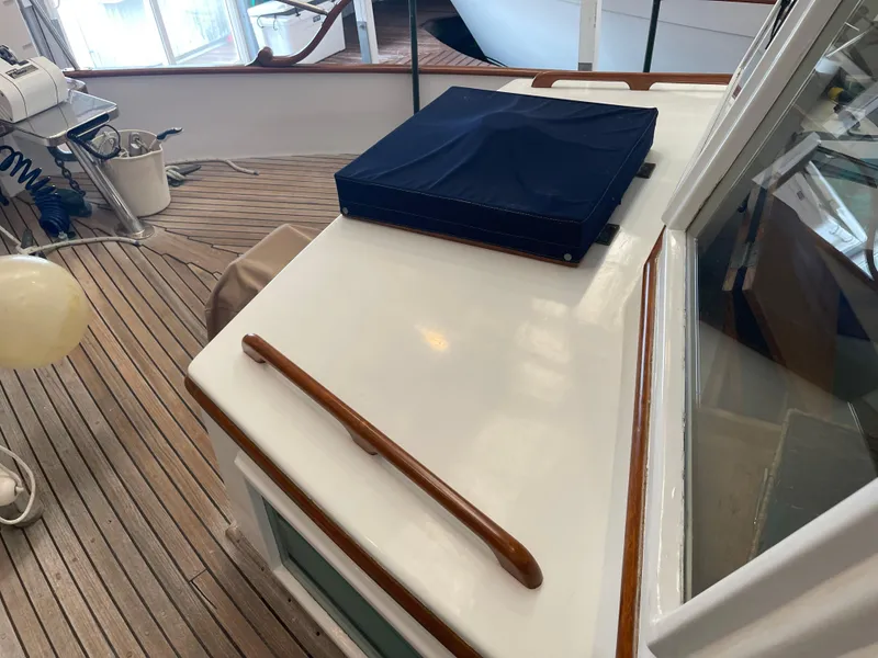 Slide: The Image of 1969 Grand Banks 36 Classic boat deck with wooden rail and blue cover. - 5