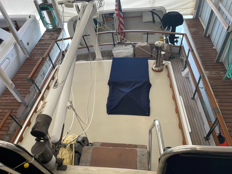 Slide: The Image of 1969 Grand Banks 36 Classic yacht deck with American flag and nautical equipment. - 6