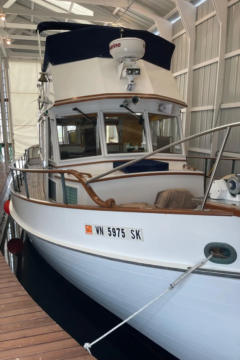 Slide: The Image of 1969 Grand Banks 36 Classic boat docked in a covered marina. - 8