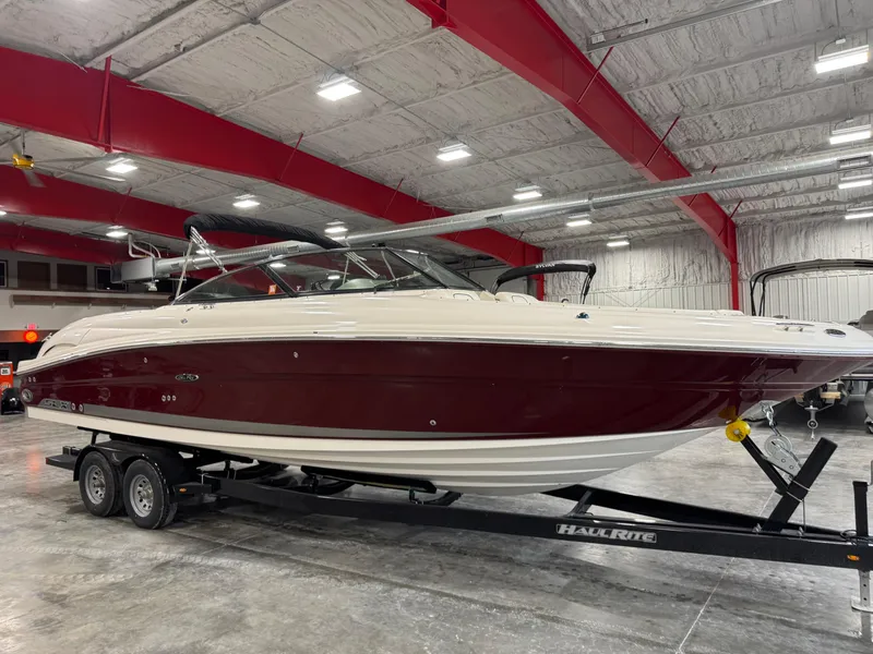 Slide: The Image of 2006 Sea Ray 290 SLX boat on trailer in indoor storage facility. - 1