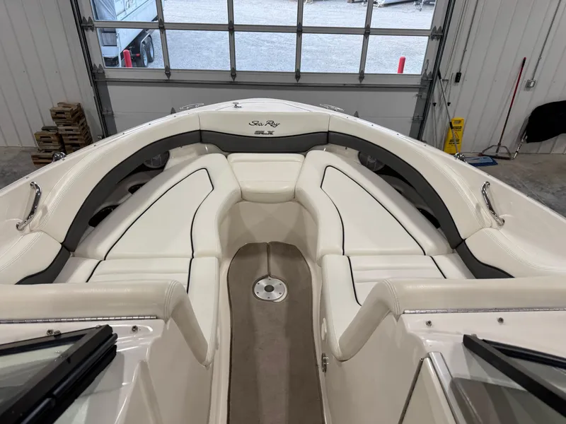 Slide: The Image of 2006 Sea Ray 290 SLX boat interior with white seating and sleek design. - 10