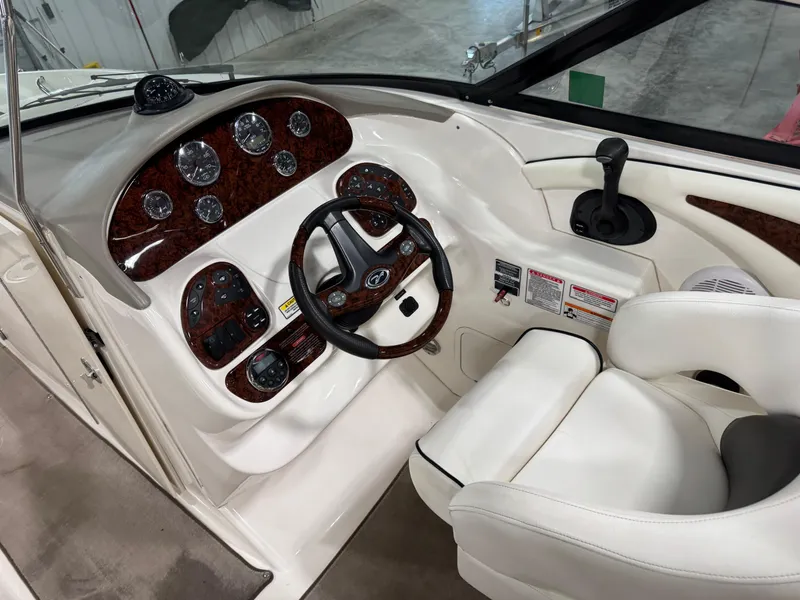 Slide: The Image of 2006 Sea Ray 290 SLX boat dashboard with steering wheel and control panel. - 12