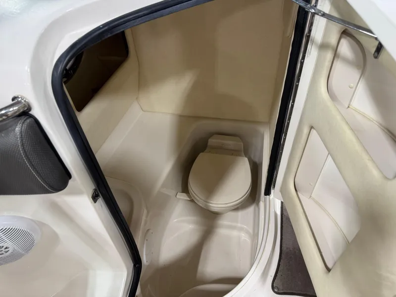 Slide: The Image of 2006 Sea Ray 290 SLX boat interior with compact marine toilet. - 13