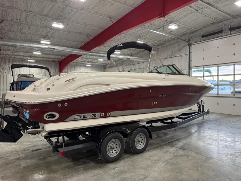 Slide: The Image of 2006 Sea Ray 290 SLX boat on trailer in indoor storage facility. - 3