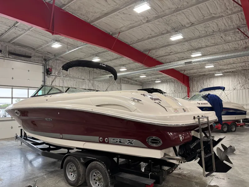 Slide: The Image of 2006 Sea Ray 290 SLX boat in a spacious indoor storage facility. - 4