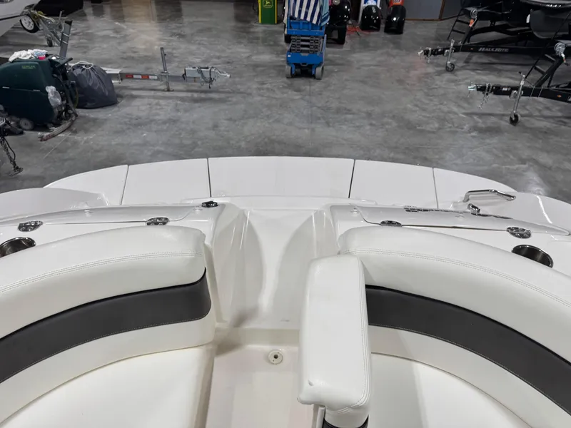Slide: The Image of 2006 Sea Ray 290 SLX boat interior with white seating in a garage setting. - 7