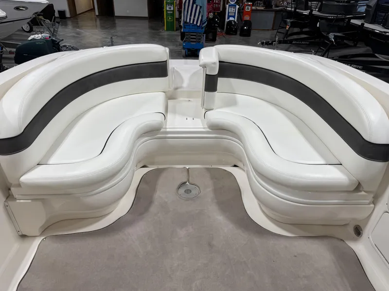 Slide: The Image of 2006 Sea Ray 290 SLX boat interior with white and black cushioned seating. - 8