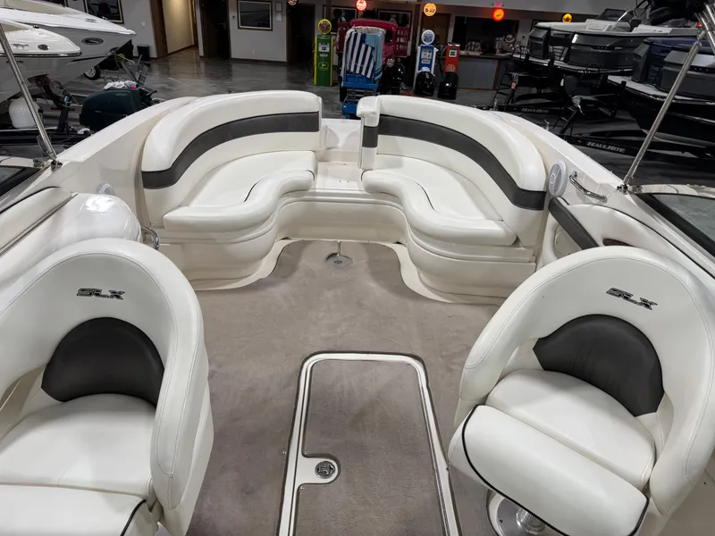 Slide: The Image of Interior of a 2006 Sea Ray 290 SLX boat with white seating and carpet. - 9
